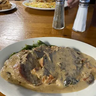 Roast pork special with green beans &amp; mashed potatoes. My husband had the Okie omelet with hash browns &amp; toast