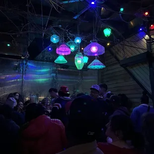 a large group of people in a dimly lit room