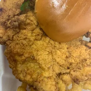 a fried chicken sandwich and onion rings