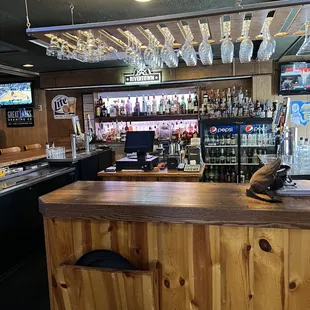 a bar with wooden counter and bar stools