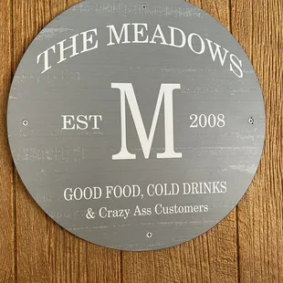 a sign for the meadows restaurant