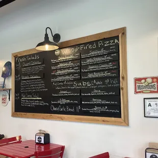 Menu board and a slight view of some seating.