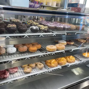 a variety of donuts in a display case