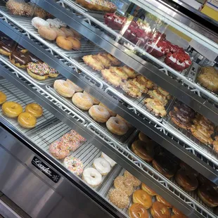 a variety of donuts in a display case