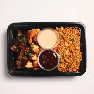 The popular Hibachi Bowl- seared steak, chicken, a healthy "fried" rice with made from scratch yumyum and ginger sauces