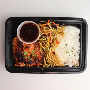 Honey-glazed salmon, carrot mix, white rice, with a side of sweet chili sauce
