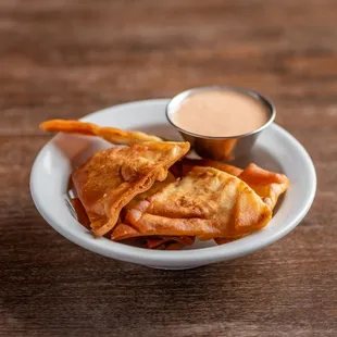 In-house made pita chips with sprinkle of oregano.