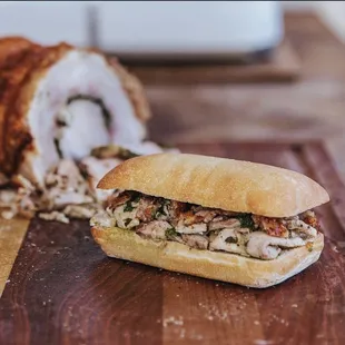 a sandwich cut in half on a cutting board
