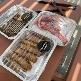 two trays of meat and sausage