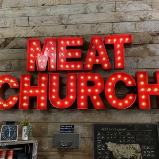 a neon sign that reads meat church