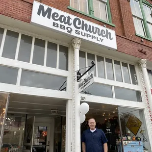 a man standing in front of a restaurant