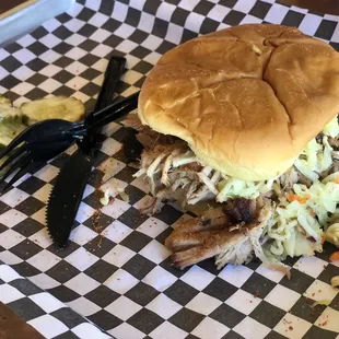 Pulled pork sandwich with slaw and bread &amp; butter pickles