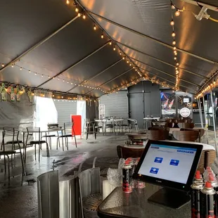tables and chairs under a tent