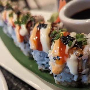 Imperial Roll - Salmon, Tuna, cream cheese, avocado, spicy mayo, Salmon Caviar, garlic aioli.