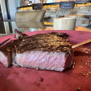 a piece of steak on a pink plate