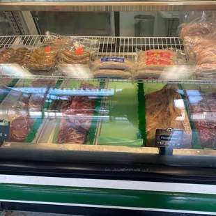 a variety of meats in a display case