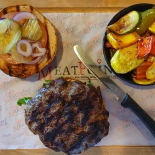 A 16oz burger with vegetables
