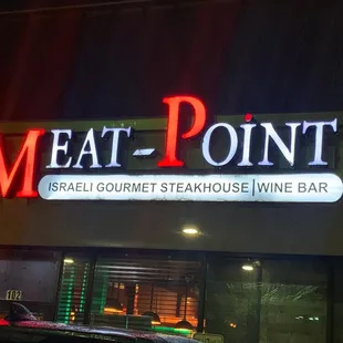 the front of the restaurant at night
