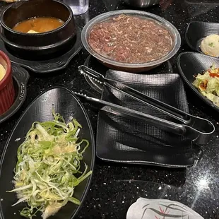 Egg and tofu soup that nobody wants. Bulgogi. Scallions and salad which were excellent but were not replenished.