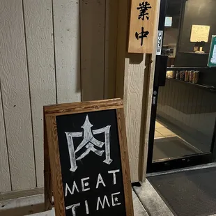 a blackboard sign outside of a restaurant