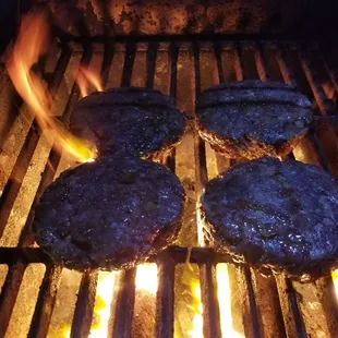 hamburgers cooking on a grill