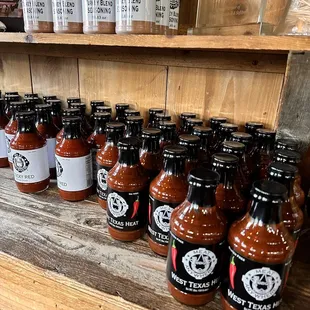 a shelf of barbecue sauces