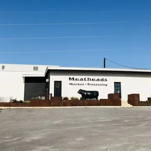 a white building with a cow on the front