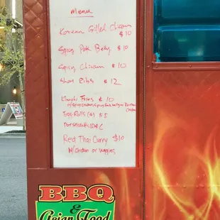 a menu on the side of a food truck