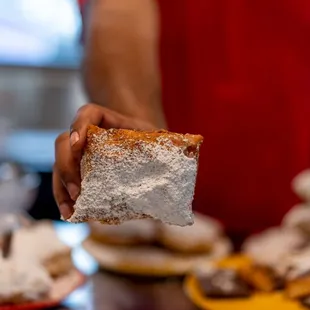 a person holding a pastry
