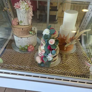 a cake display in a glass case