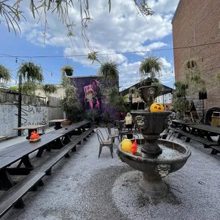 a fountain and benches in a courtyard