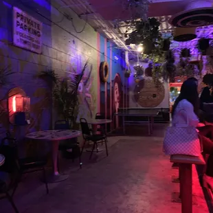 When you first walk in, this is to the left. Bar area, small tables with chairs &amp; a couch along with a ping pong table.