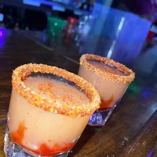 two cocktails on a bar
