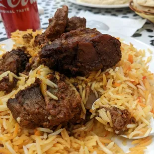 a plate of food with rice and meat