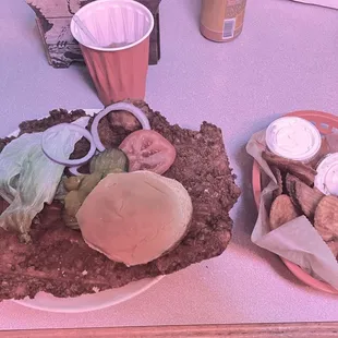 Breaded Pork Tenderloin and fried potato slices.
