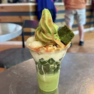 Meccha 8 parfait with soft serve, red bean, matcha jelly, whipped cream, waffle crackers, mochi balls, strawberry sauce, and matcha cake
