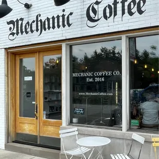 a table and chairs outside a coffee shop