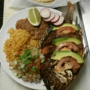 a plate of fish and rice