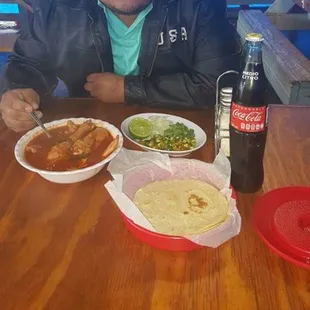 a man sitting at a table with food