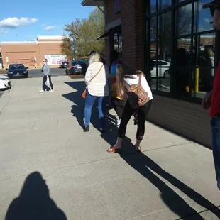 people walking down the sidewalk