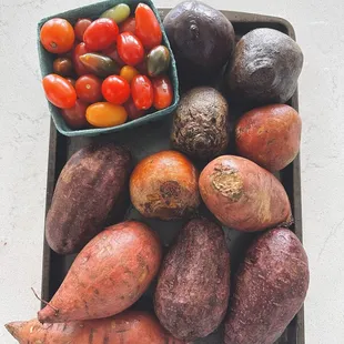 Sweet potatoes(purple and orange), beets (gold and red) grape heirloom tomatoes.