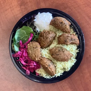 Falafel bowl with rice, greens, and garlic sauce