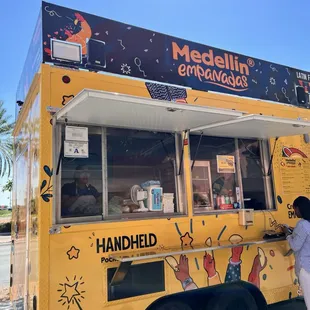 a woman ordering food from a food truck