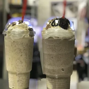 two cups of milkshake with whipped cream and chocolate
