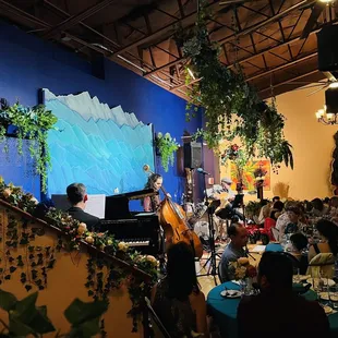 a group of people sitting at tables in a restaurant