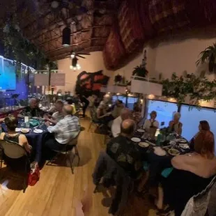 people sitting at tables in a restaurant