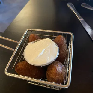 a basket of doughnuts and a bowl of cream