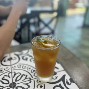 a glass of iced tea on a table