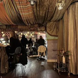 people sitting at tables in a restaurant