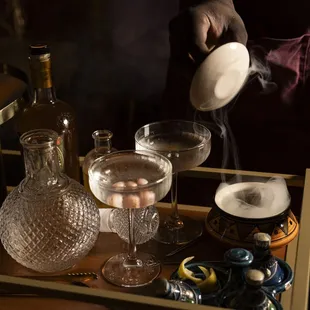 a person pouring water into a glass